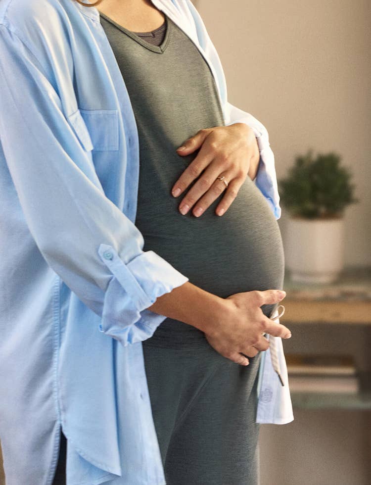 Pregnant woman holding bump