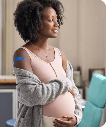 Actor portrayal of a pregnant woman feeling her belly
