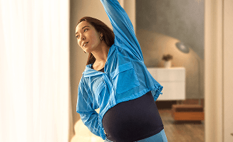 Actor portrayal of a pregnant woman stretching