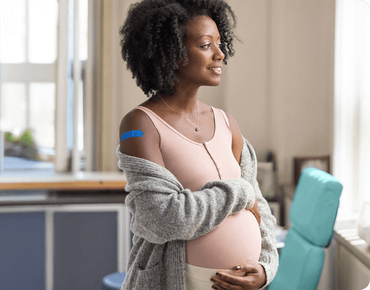 Actor portrayal of a pregnant woman feeling her belly